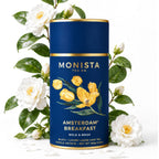 Monista Tea Co. Amsterdam Breakfast tea canister with floral design and white flowers in the background