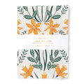 A linen tea towels with floral pattern on a white background