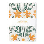 A linen tea towels with floral pattern on a white background