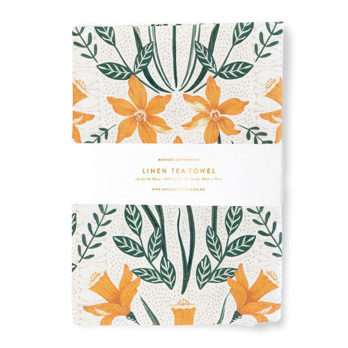 A linen tea towels with floral pattern on a white background