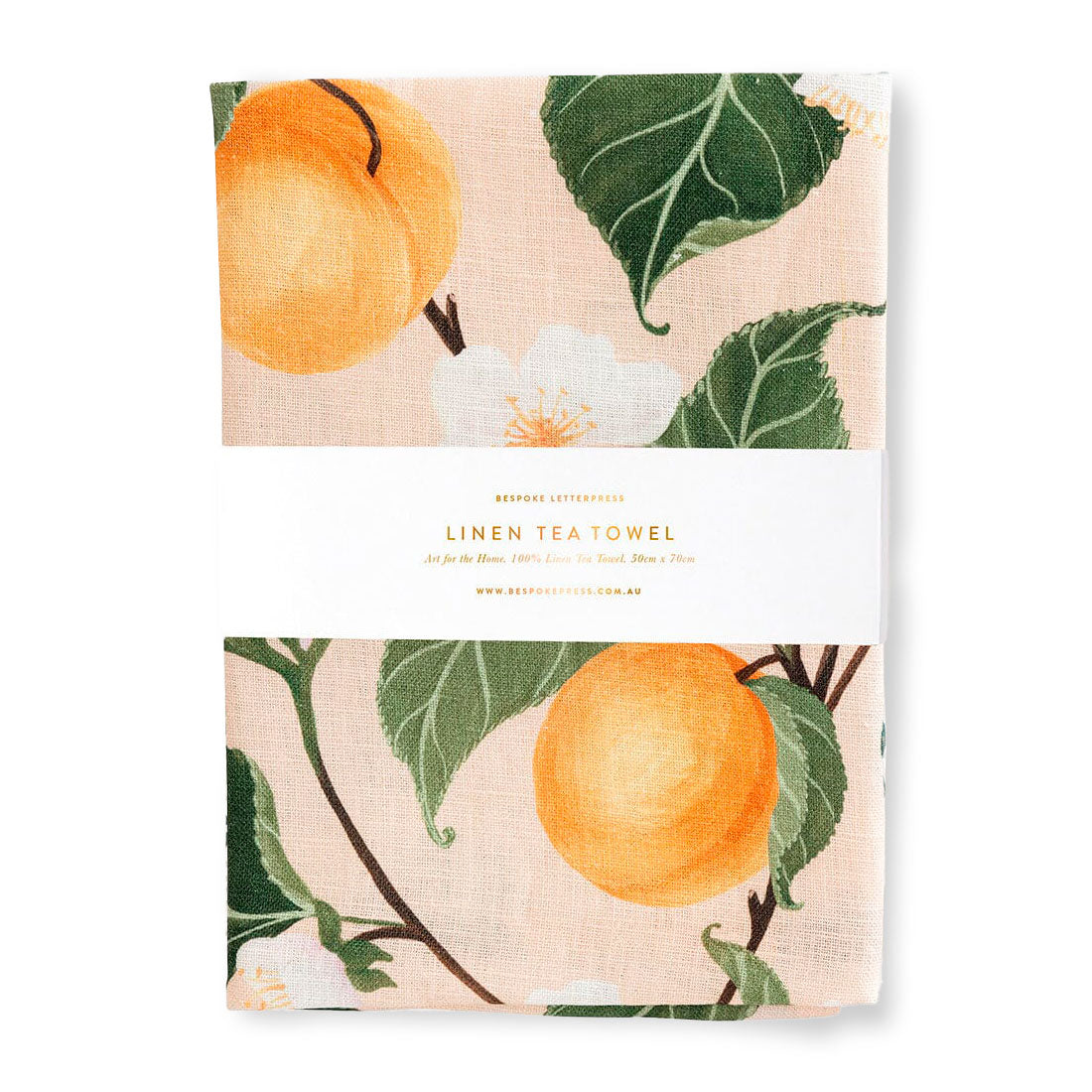 Linen tea towel with  peaches and leaf pattern on a white background