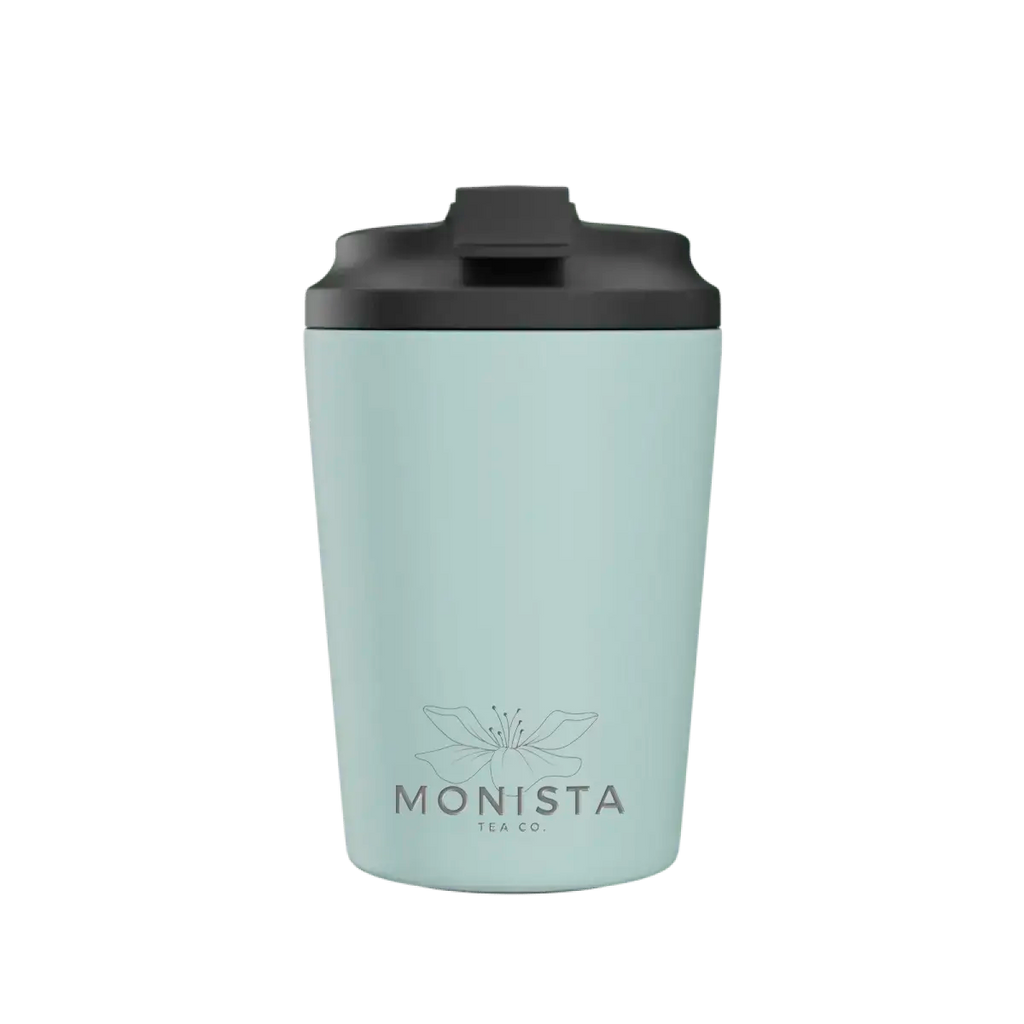 Pink insulated cup with a black lid and 'Monista Tea Co.' flower logo on a white background