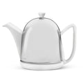 White ceramic teapot with a stainless steel dome cosy on a white background