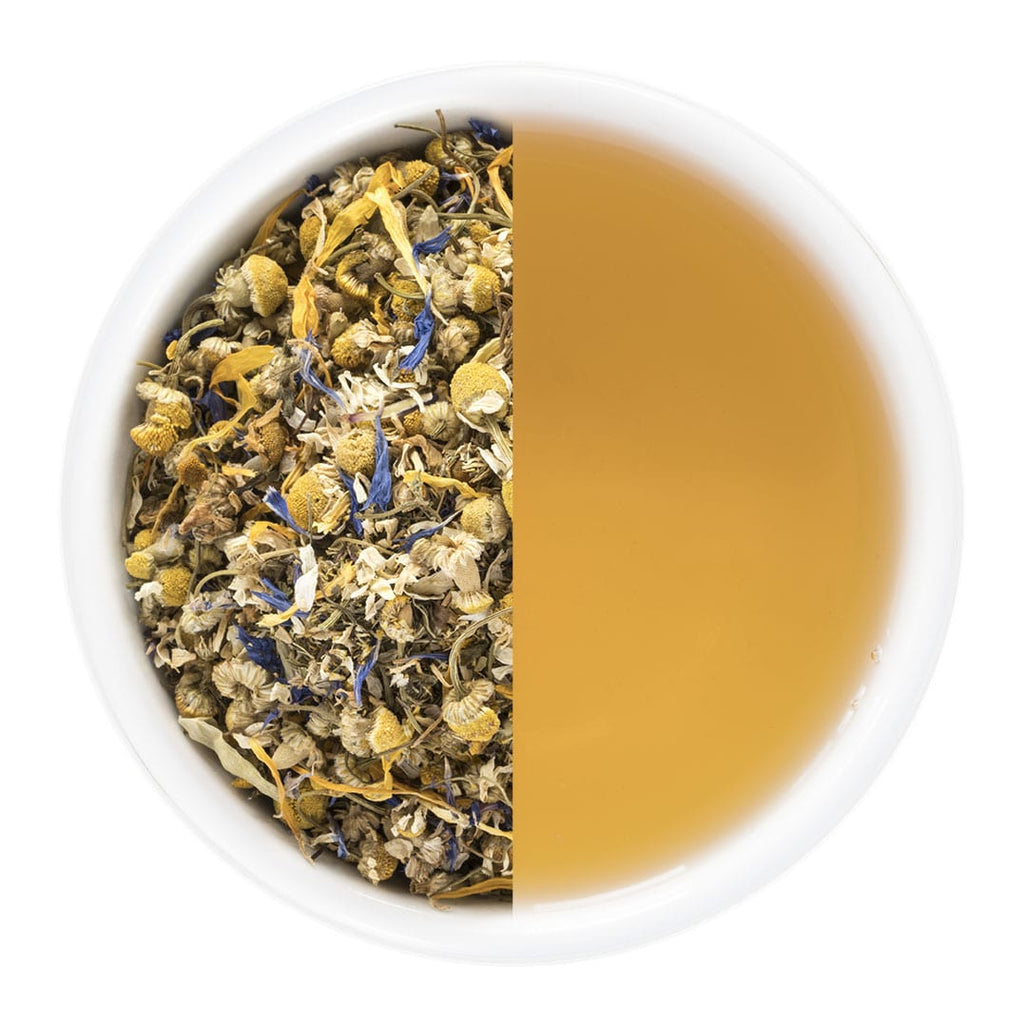 Tea cup divided into two halves, one with dry herbs and flowers, the other with brewed tea.