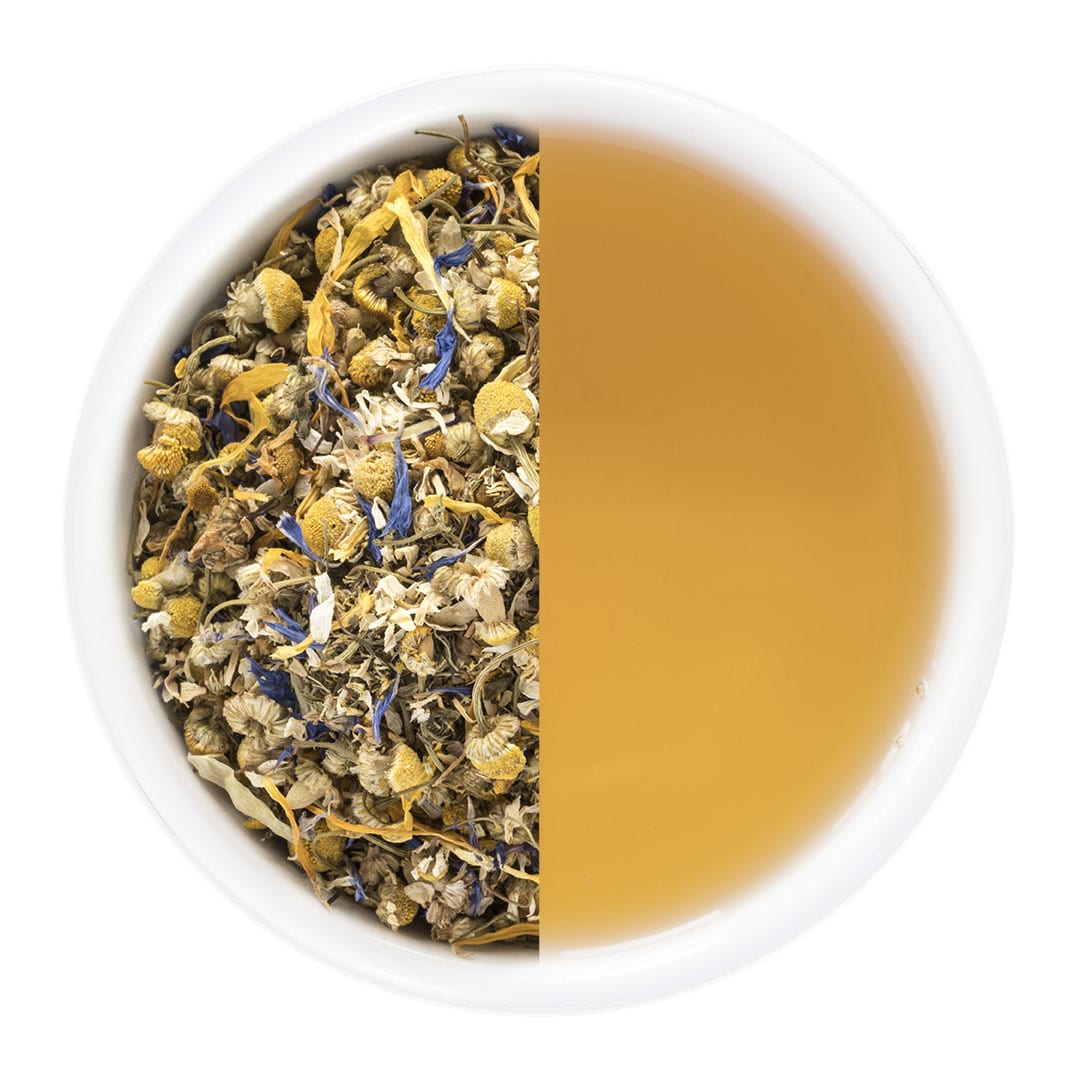 Tea cup divided into two halves, one with dry herbs and flowers, the other with brewed tea.
