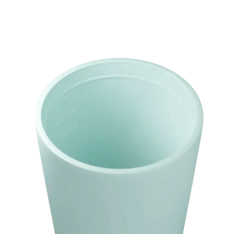 Close-up of a pale mint cup interior showing embossed ounce measurement lines