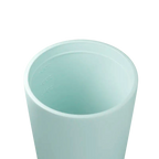 Close-up of a pale mint cup interior showing embossed ounce measurement lines