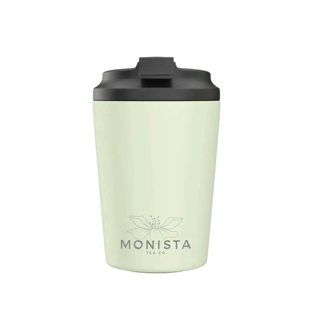 Pale green insulated cup with a black lid and 'Monista' branding on a white background