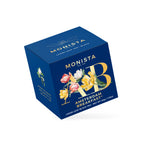 Navy blue Amsterdam Breakfast tea box with a gold tulip monogram design shown at an angle
