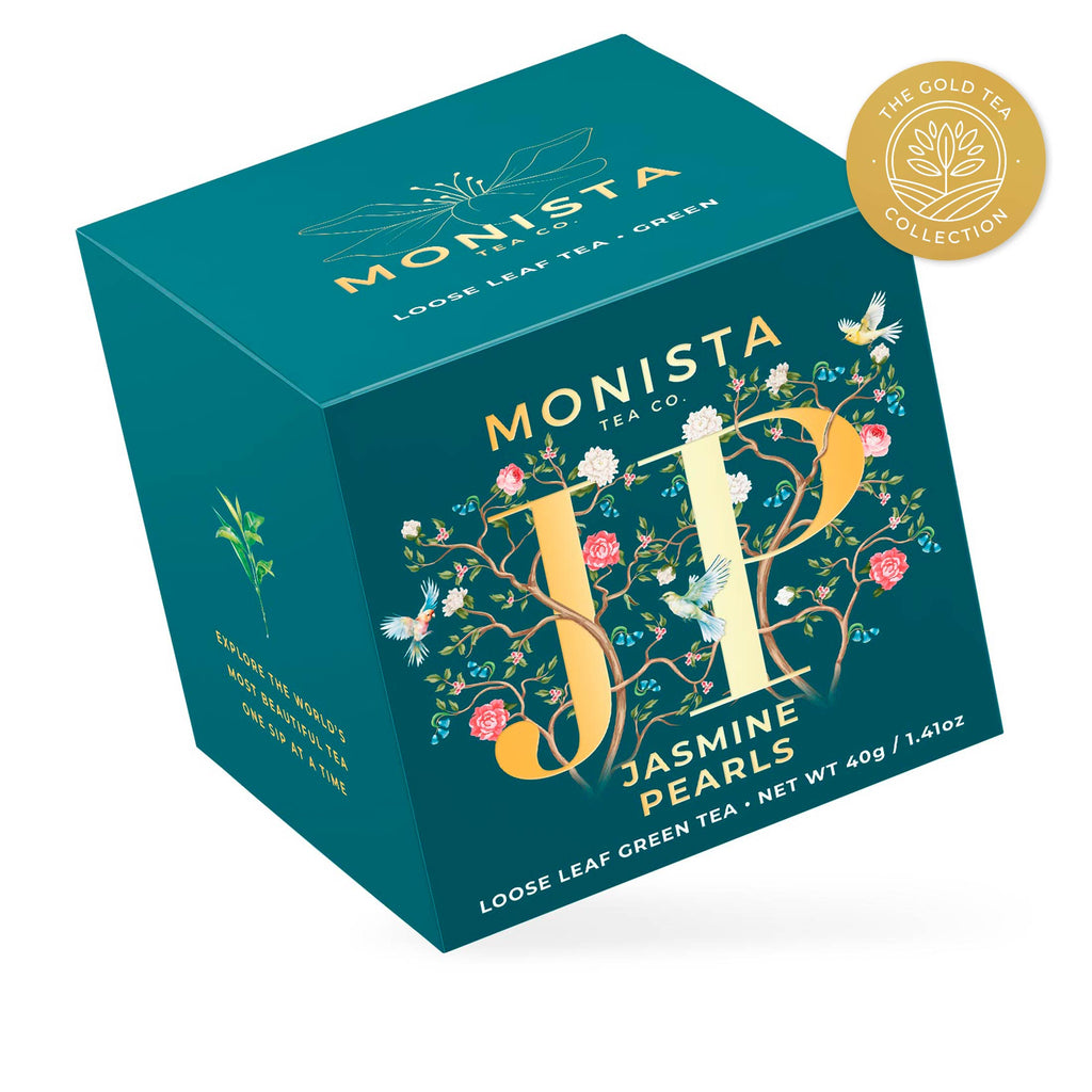 Teal Jasmine Pearls tea box with gold floral monogram design shown at an angle