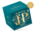 Teal Jasmine Pearls tea box with gold floral monogram design shown at an angle