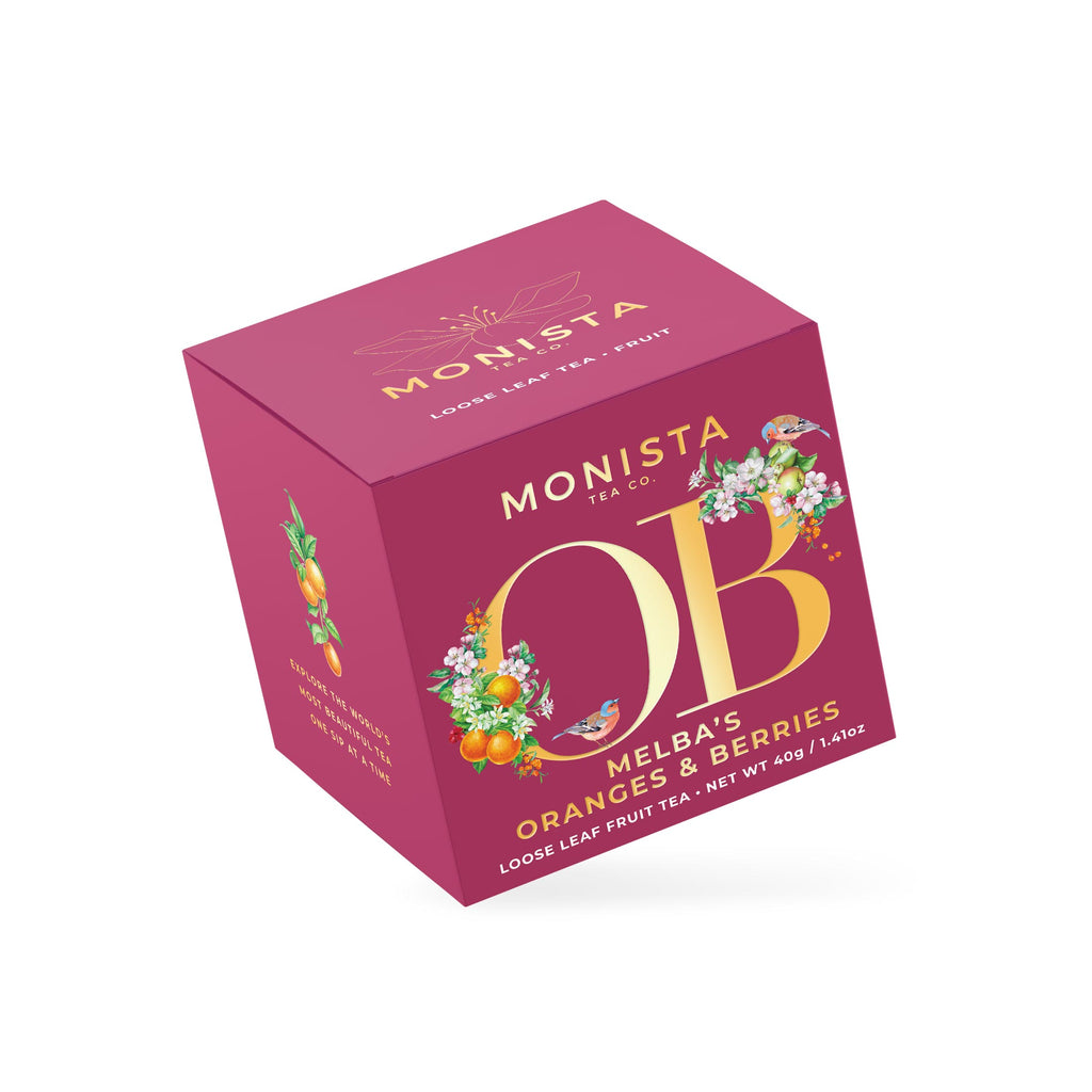 Magenta Melba's Oranges & Berries tea box with a gold birdcage monogram design shown at an angle