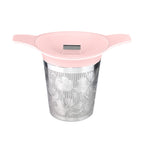 Tea infuser with floral design and pink lid on a white background