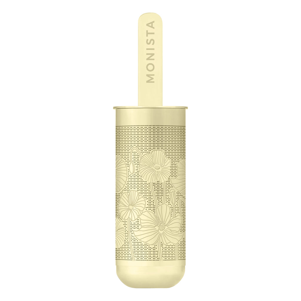 Gold spoon with 'Monista' engraved on the handle on a white background