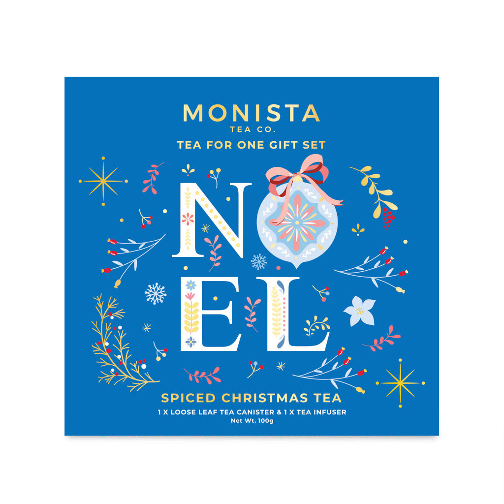 A square blue Monista Tea Co. gift set box labeled 'NOEL' with festive illustrated ornaments, flowers, and stars, and text reading 'Spiced Christmas Tea' and 'Tea for one gift set.