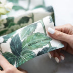 Close-up of folded hydrangea and leaf print linen fabric with a designer's name printed on it