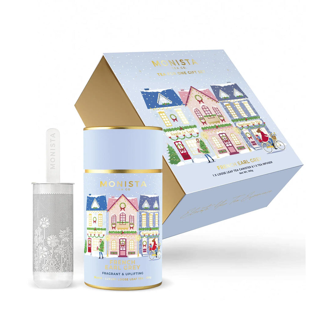 Tea canister with decorative packaging featuring illustrated houses on a white background