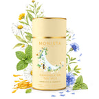 Camomile On The Nile tea canister surrounded by chamomile flowers and mint leaves on a white background