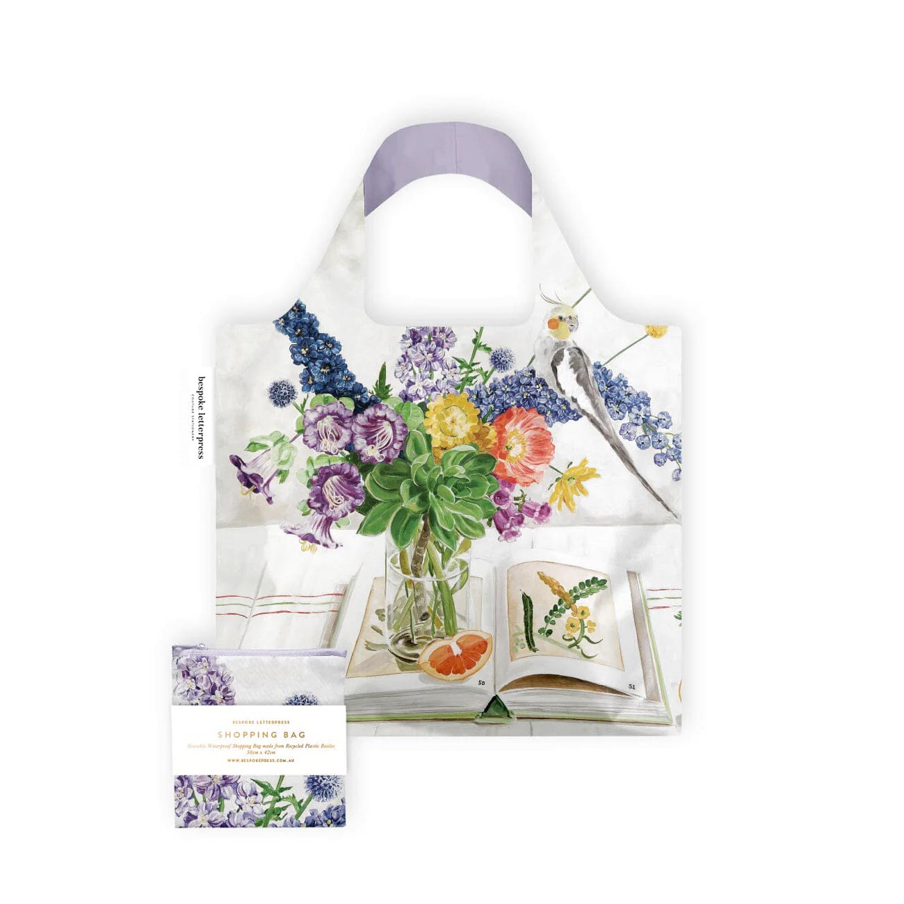 Reusable shopping bag printed with a cockatoo and flower bouquet illustration, with matching pouch