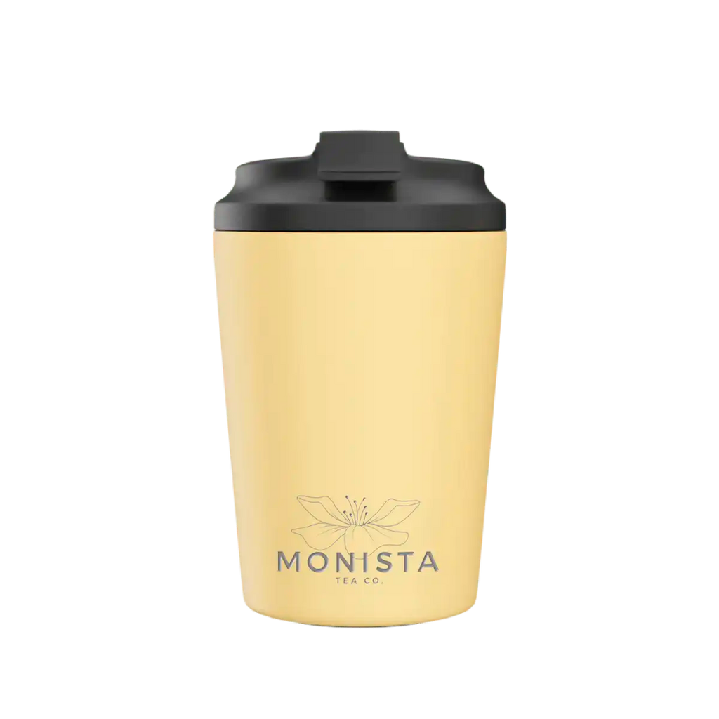 Yellow tumbler with black lid on a white background, featuring the Monista Tea Co. logo.