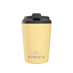Yellow tumbler with black lid on a white background, featuring the Monista Tea Co. logo.