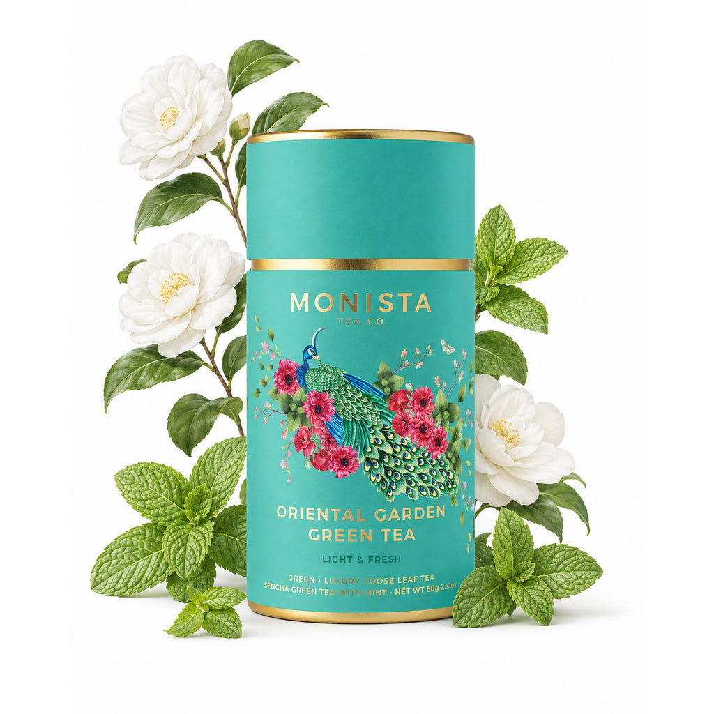 Oriental Garden Green Tea canister surrounded by white camellia flowers and mint leaves on a white background