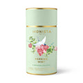 Sage green tea canister with a bird and rose design and 'Persian Mint' branding on a white background