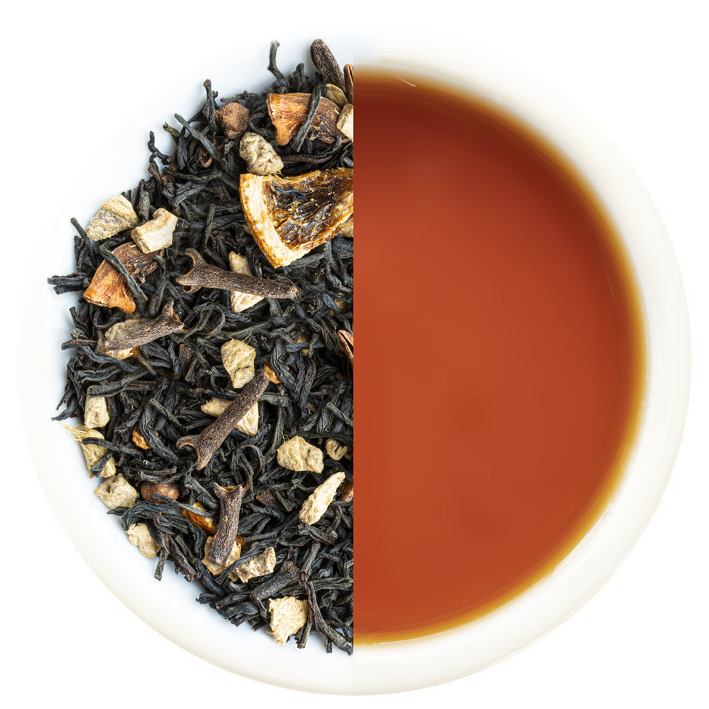 Tea leaves on one side and a cup of brewed tea on the other side.