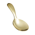 Gold spoon with 'Monista' engraved on the handle on a white background
