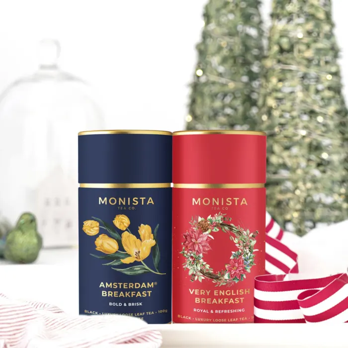 two tea canisters in a christmas setting