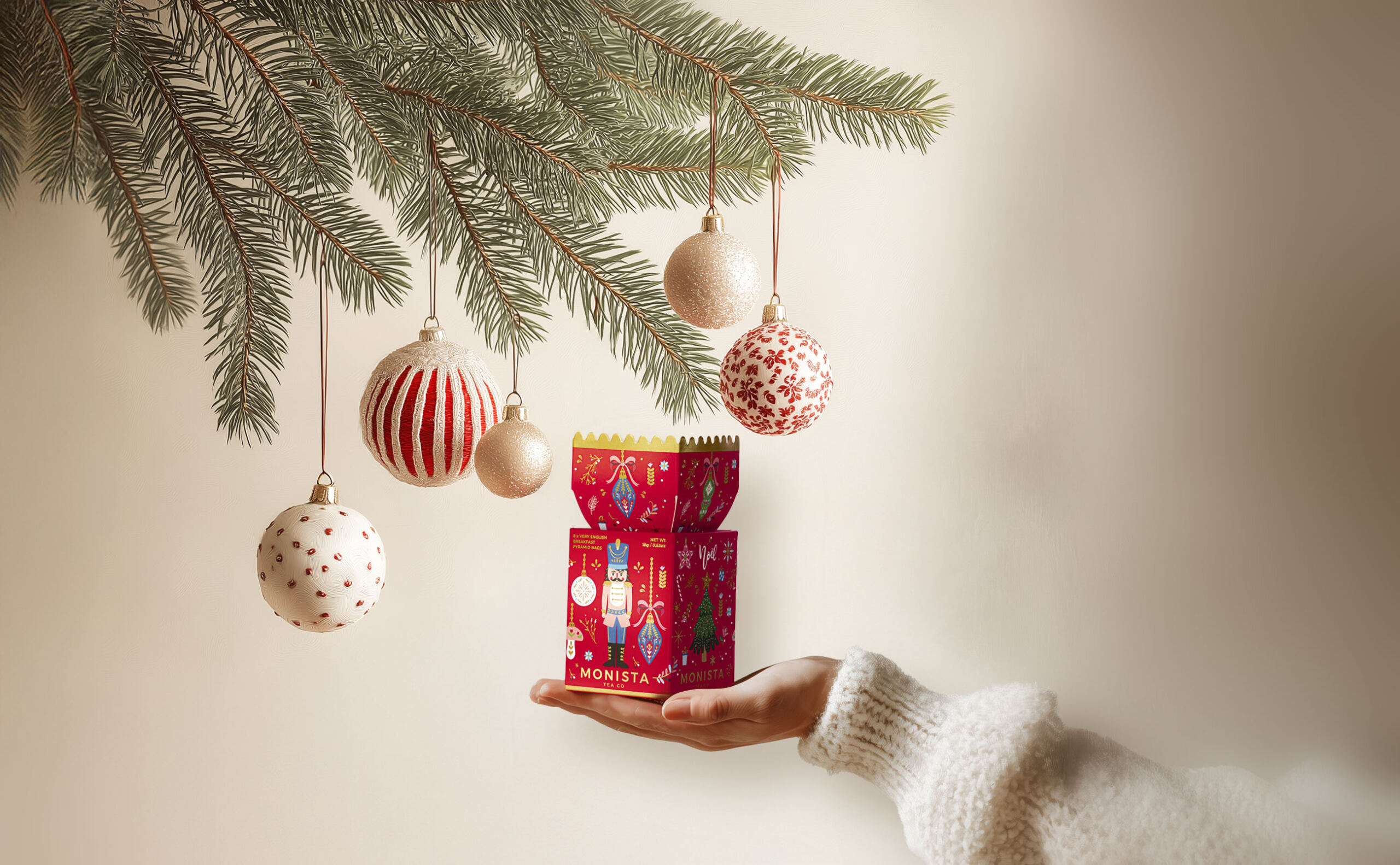 lady with her hands under a christmas decoration
