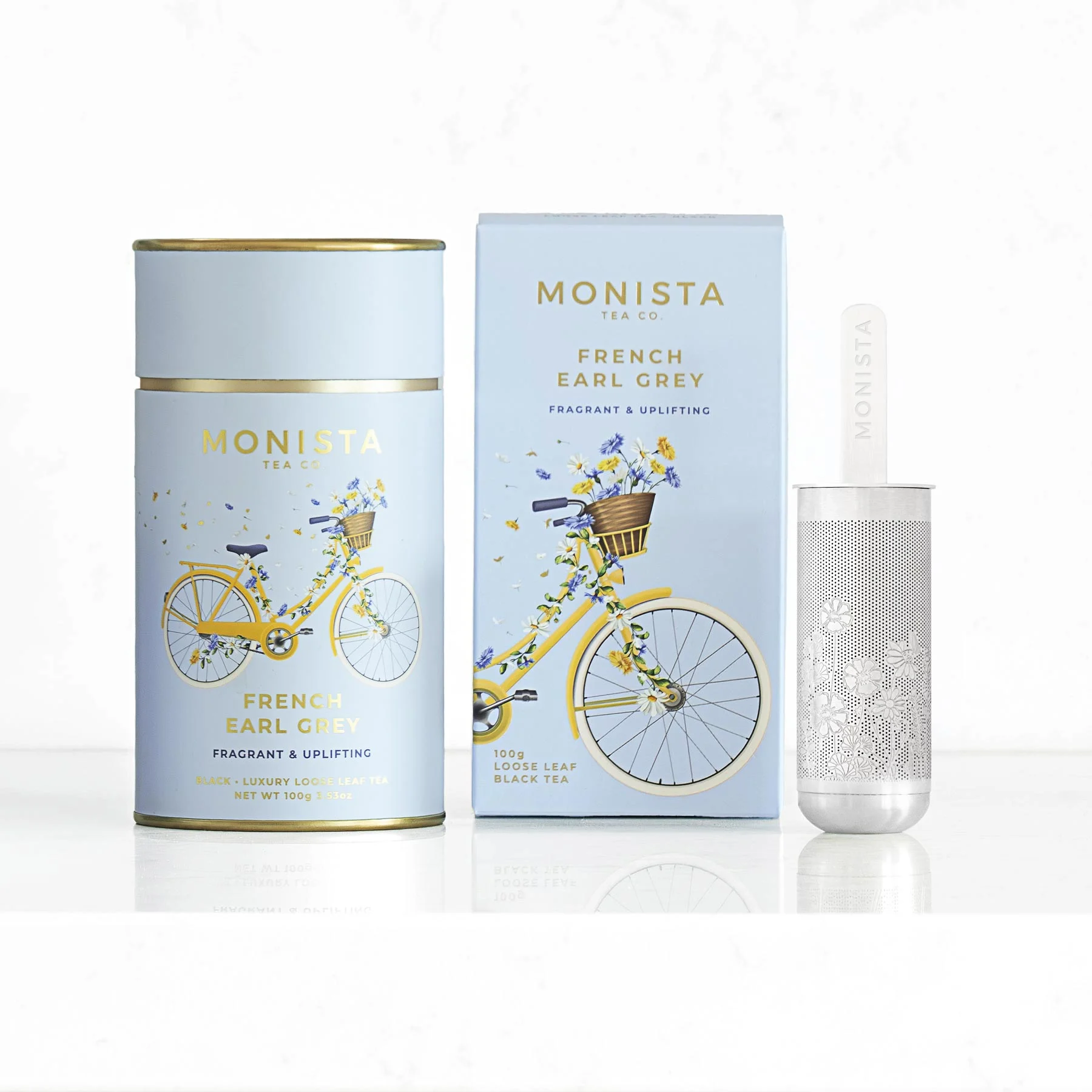 A tea canister and a refill box and infuser