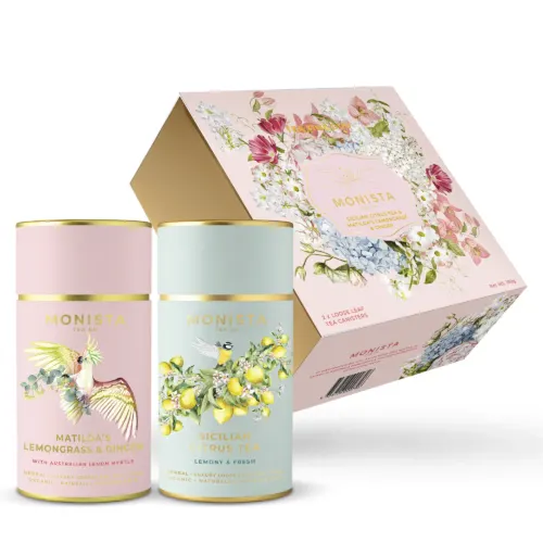 2 pretty tea canisters in front of gift box