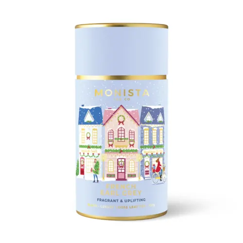 blue tea canister with little Christmas houses