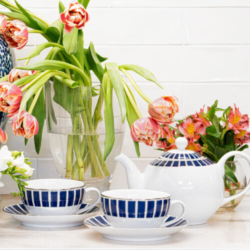 Tea cups and saucers with teapot and tulips