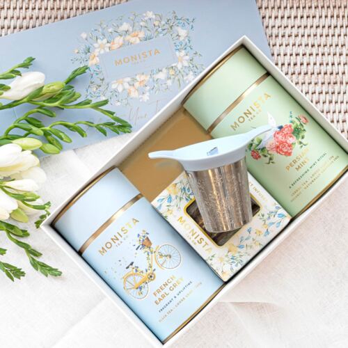 Pretty tea gift set with blue and green tea canisters with tea strainer