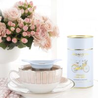Tea cup, infuser and tea canister with flowers