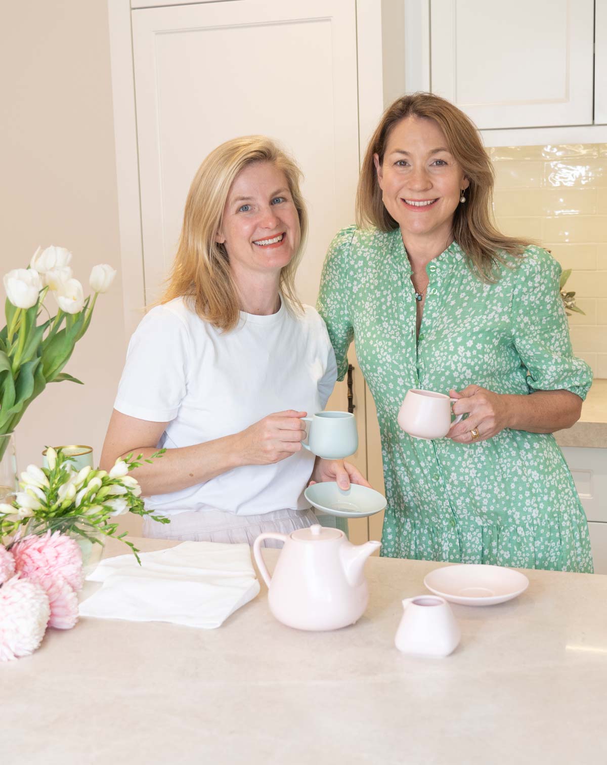 two ladies drinking tea in kitchen