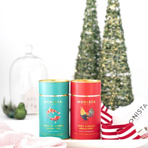 two tea canisters in festive scene
