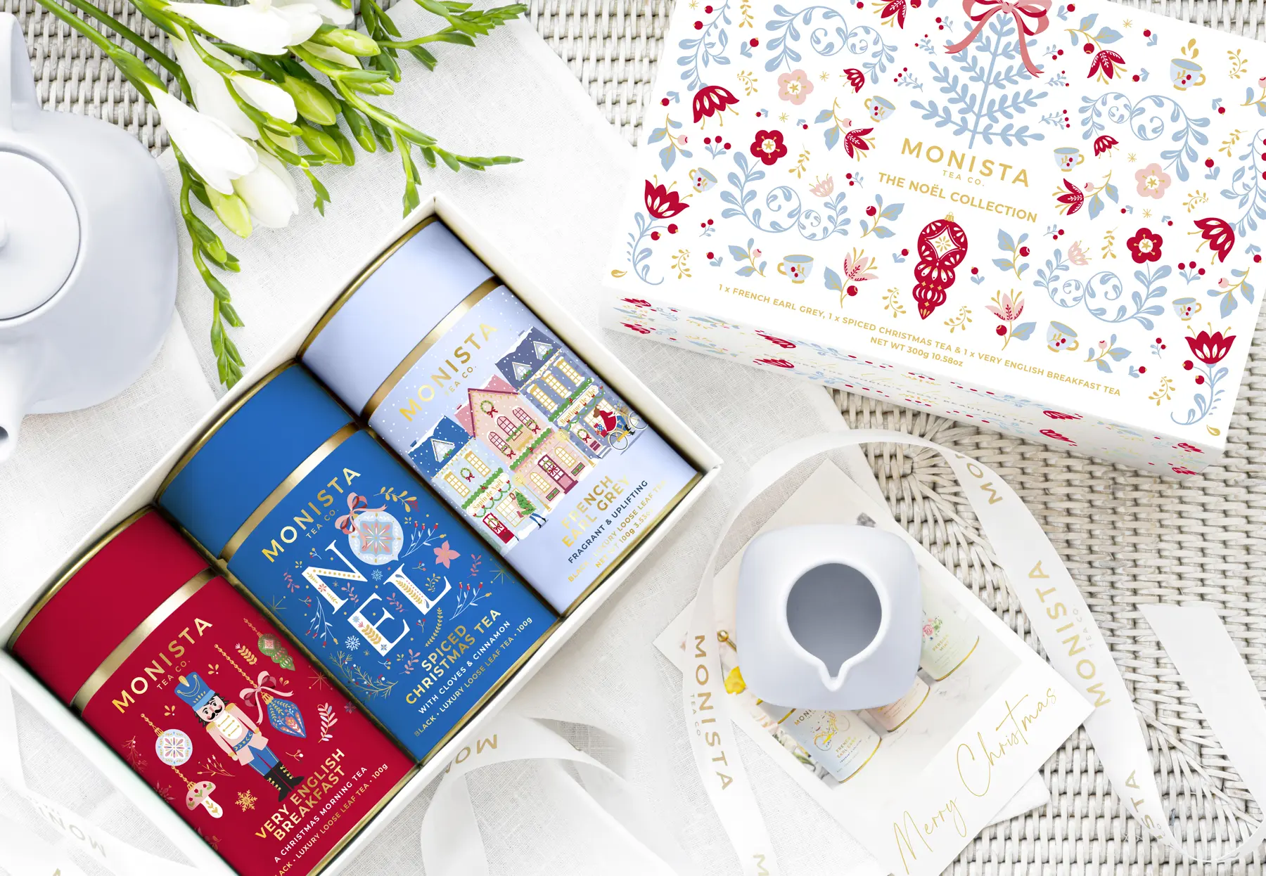 three christmas tea canisters with flowers ribbon and gift box